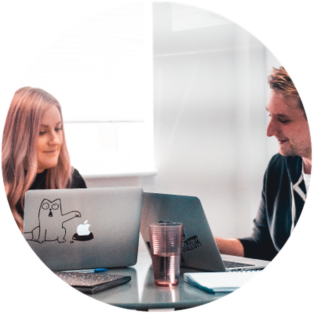 two people sat in front of laptops collaborating on some testing