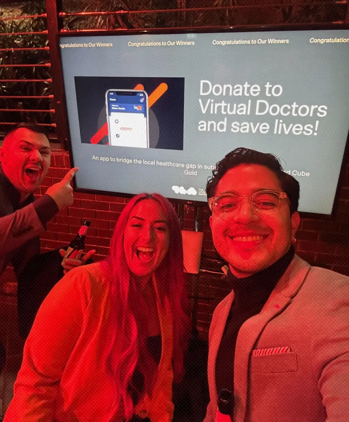 The team's celebratory selfie with our award winning project displayed on screen in the background.